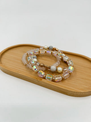 Beaded bracelet set with clear beads, iridescent details, and pearls