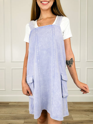 Light blue overall dress with patch side pockets and adjustable straps, cotton blend