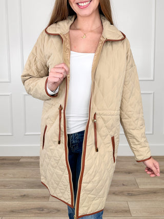 Sand quilted long-sleeve jacket with full zip and red-trim pockets, stand collar