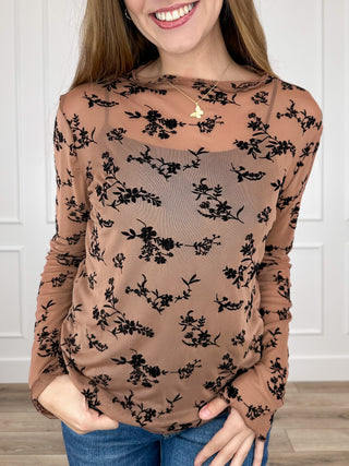 Tan sheer mesh long-sleeve top with black floral print, round neckline
