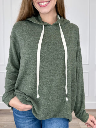 Green heather knit long-sleeve hooded top with white drawstring ties.