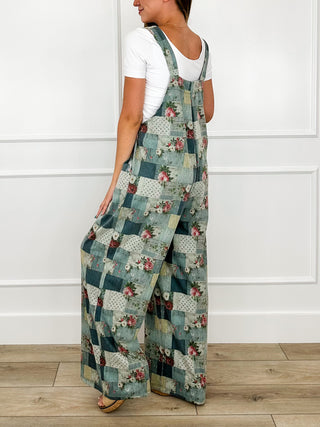 Teal patchwork floral overalls with adjustable straps, side view