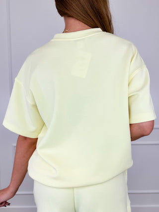 Lightweight short-sleeve crewneck top, pale yellow, back view
