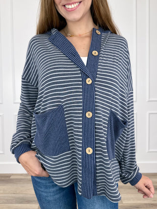 Blue striped hooded button-up long-sleeve top with front pockets and wooden-look buttons