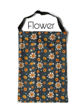 Dark navy candy bag with orange flowers and pumpkin pattern.