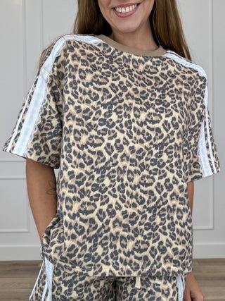 Leopard print knit short-sleeve top with crew neck and white side stripe trim, tan base