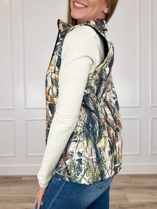 Camouflage puffer vest, side view with zip front and quilted sleeveless design