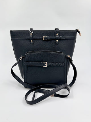 Black faux leather shoulder bag with top flap, front pocket, and adjustable crossbody strap
