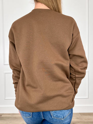 Brown crewneck sweatshirt back view with long sleeves and ribbed hem