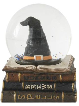 Snow globe with black witch hat on stacked spell books, clear dome and base