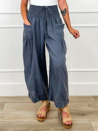 Dark blue high-rise wide-leg cropped pants with elastic waist, drawstring tie, pockets
