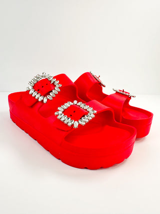 Red platform double-strap slide sandals with jeweled square buckles