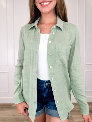 Cotton long-sleeve button-up top in light green, button front and pointed collar