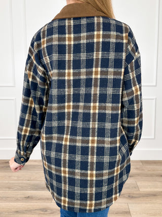 Navy and tan plaid flannel shacket back view, long sleeves, collared button front
