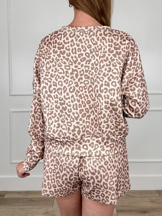 Leopard print set viewed from back, with long-sleeve top and high-rise shorts