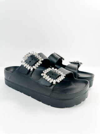 Black platform double-strap slide sandals with jeweled square buckles