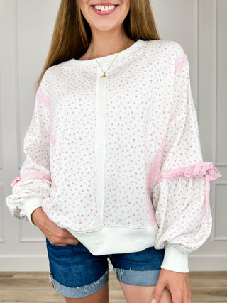 Cotton blend long sleeve top, white with small pink speckle print and pink ruffle cuffs