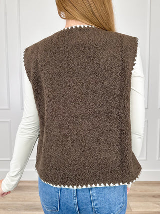 Brown sherpa vest back view with white trim hem