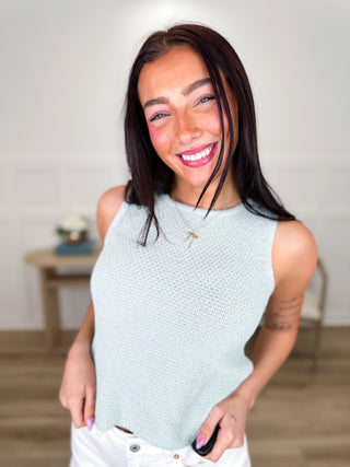 Light blue knit cropped sleeveless top with crew neckline and textured stitch detail