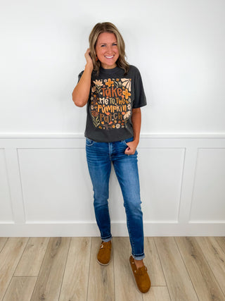 Casual outfit: black graphic T-shirt, blue jeans, brown ankle boots