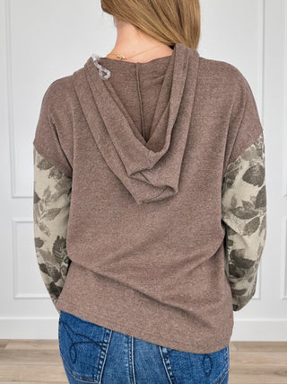 Brown hooded long-sleeve top with draped back hood and camo sleeve print
