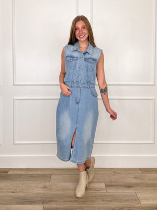 Medium wash denim sleeveless midi dress with button front, side slit, and pockets