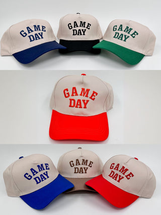 Three Game Day embroidered hats: beige crowns with blue, black, and green brims