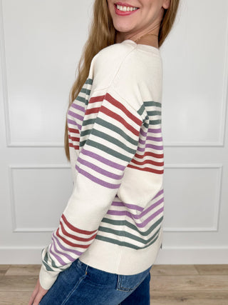 Ivory knit long-sleeve sweater with multicolor horizontal stripes, side view