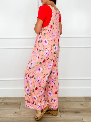Pink floral printed overalls with adjustable straps and wide straight legs