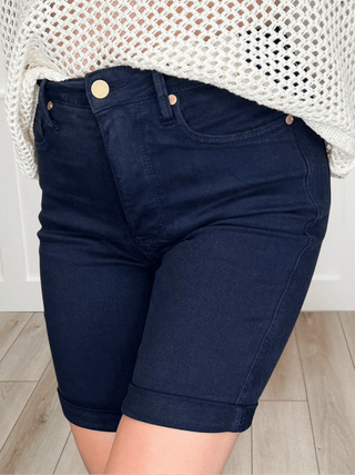 High-rise navy denim bermuda shorts with button front and side pockets
