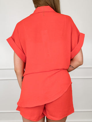 Orange high-rise shorts set with matching short-sleeve button top, back view