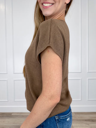 Brown knit cap-sleeve top, short sleeves and button-front placket viewed from side