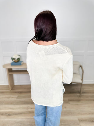 Ivory knit long-sleeve sweater top with crew neckline, back view