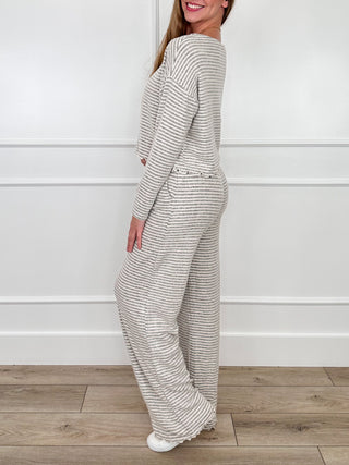 Grey striped lounge set, side view of long-sleeve crew top and wide-leg pants