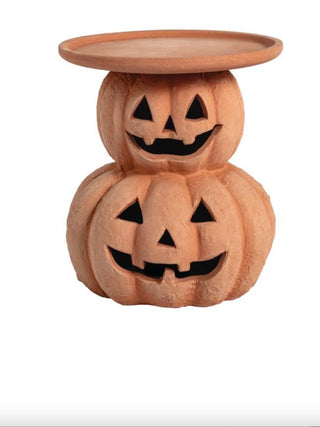 Terracotta jack-o’-lantern pillar stand with carved pumpkin face openings