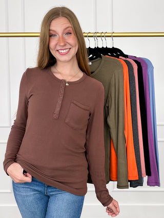 Brown long-sleeve henley top with button placket and chest pocket