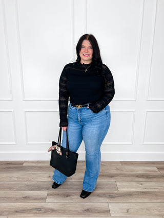 Medium-wash tummy control straight-leg jeans with distressed detailing and button closure