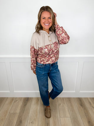 Floral hooded jacket top and blue jeans with tan ankle boots, full-body view