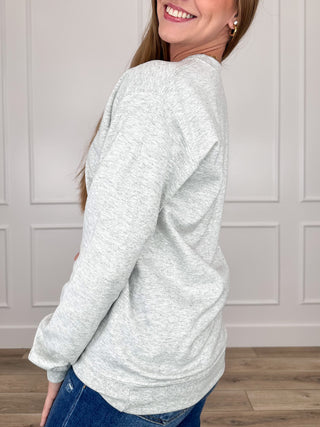 Grey crewneck sweatshirt with long sleeves and front graphic print