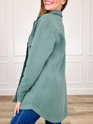 Taupe long-sleeve shacket in profile with button front, point collar, and chest pockets