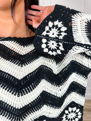 Black knit sleeve with white chevron stripes and flower pattern