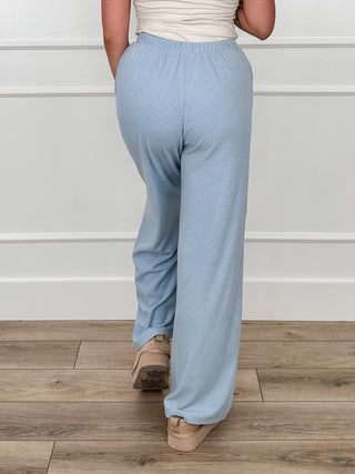 Light blue high-rise striped pants with cuffed hems and covered button closure