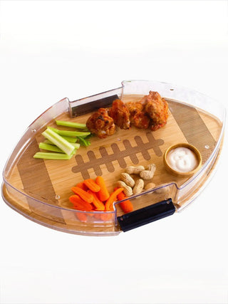 Wood serving board with football-shaped slots and divided sections for snacks and veggies