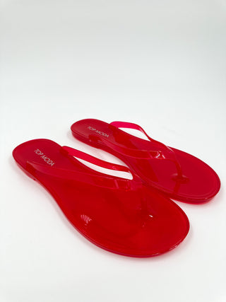 Red jelly sandals with thong straps, glossy translucent flip-flops