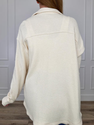 Cream knit button-up shacket back view with long sleeves and open notch collar