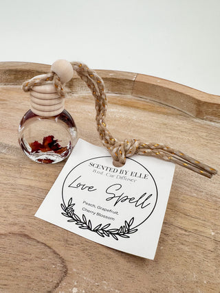 Glass scent diffuser bottle with wooden stopper and rope cord, label: Love Spell