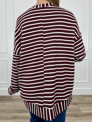 Knit long-sleeve top in burgundy and white stripes, back view with curved hem
