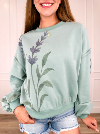 Cotton blend pullover top in sage green with floral graphic and long sleeves