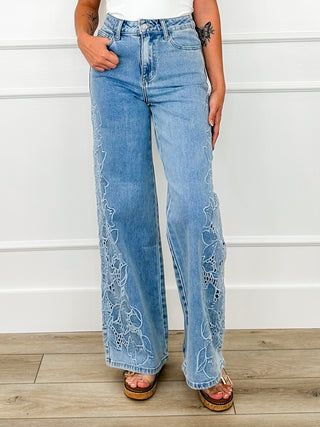 Light wash high-rise wide-leg jeans with embroidered lace panels at the legs
