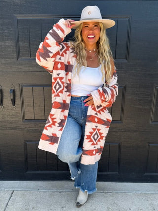 Cream knit long-sleeve cardigan with red and orange geometric pattern, open front